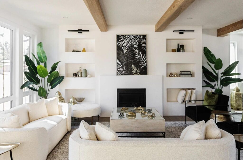 Accessories stylized on shelves on either side of a fireplace.